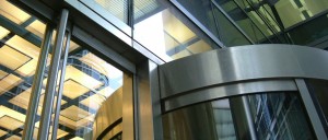 Revolving door entrance to citibank, Canary Wharf - Stainless steel and glass revolving door designed, fabricated and installed by John Desmond Ltd. - Architect: Foster & Partners