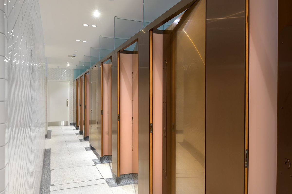 Interior of upgraded WCs Victoria Station, London with 18 mm thick glossy white brick and curved terrazzo skirting for ease of cleaning.  Client: Network Rail Architects: Landolt + Brown Fitout: Maxwood Washrooms PVD coloured stainless steel by Double Stone Steel Architectural metalwork by John Desmond Ltd Interior of upgraded WCs Victoria Station, London with 18 mm thick glossy white brick and curved terrazzo skirting for ease of cleaning.  Client: Network Rail Architects: Landolt + Brown Fitout: Maxwood Washrooms PVD coloured stainless steel by Double Stone Steel Architectural metalwork by John Desmond Ltd