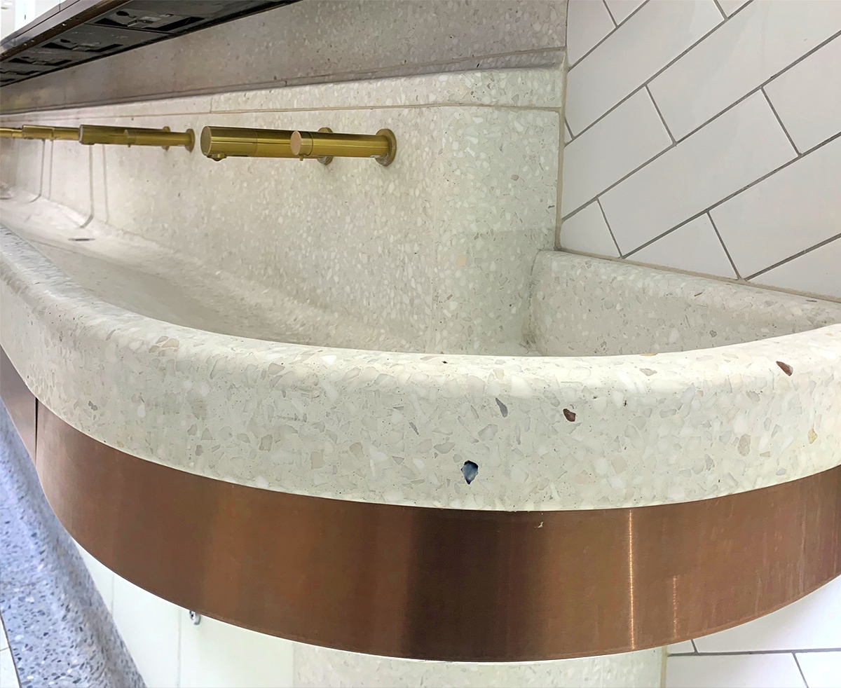 Communal basin with curved perimeter and horizontal banding in PVD coloured stainless steel Bronze No 4 Brushed finish to match taps.  Client: Network Rail Architects: Landolt + Brown Fitout: Maxwood Washrooms PVD coloured stainless steel by Double Stone Steel Architectural metalwork by John Desmond Ltd Communal basin with curved perimeter and horizontal banding in PVD coloured stainless steel Bronze No 4 Brushed finish to match taps.  Client: Network Rail Architects: Landolt + Brown Fitout: Maxwood Washrooms PVD coloured stainless steel by Double Stone Steel Architectural metalwork by John Desmond Ltd