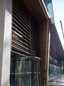 Brise soleil, canopy and column exterior metalwork. - 15 Fetter Lane, EC4A, London. - Architects: McBains - Bronze PVD coloured textured stainless steel Brise soleil, canopy and column in Chocolate. - Architectural Metalwork and PVD by John Desmond Ltd.