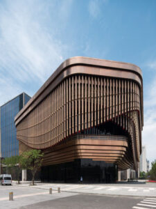 Façade in Rose Gold PVD coloured stainless steel tubular drops. - The Arts and Cultural Centre, Shanghai Bund Financial Centre, China. - Architects: Foster & Partners; Heatherwick Studio - PVD coloured stainless steel: John Desmond Ltd.