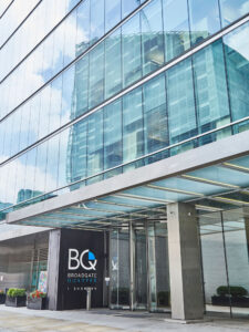 Frameless Glazed satin stainless steel canopy cantilevered from the building core. - Office building, 1 Broadgate Quarter, Snowden St, London, EC2A 2AW. - Architects: John Robertson Architects - Architectural metalwork: fabricated and installed by John Desmond Ltd.