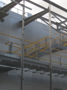 Maintenance walkway and stairs with stainless steel mesh barrier. - Wood Lane Underground Station, Holborn, London. - Architectural metalwork: John Desmond Ltd in partnership with Westfield Architectural metalworks